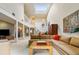 Spacious living room featuring a vaulted ceiling, skylight, and an open floor plan at 2770 S Elmira St # 42, Denver, CO 80231