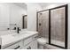 Modern bathroom showcasing a walk-in shower and black fixtures, with an elegant white vanity at 9359 Russell Cir, Arvada, CO 80007