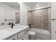 Bright bathroom features a bathtub and shower, modern fixtures, and white vanity at 9359 Russell Cir, Arvada, CO 80007