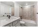 Bright bathroom features a bathtub and shower, modern fixtures, and white vanity with single sink at 9359 Russell Cir, Arvada, CO 80007