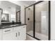 Modern bathroom with a glass shower, stylish black fixtures, and vanity with white cabinets at 9359 Russell Cir, Arvada, CO 80007