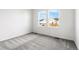 This carpeted room, painted in a pleasing white, is lit by two large windows at 9359 Russell Cir, Arvada, CO 80007
