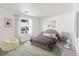 Charming bedroom showcasing soft colors, a cozy bed, and unique decor for a comfortable and inviting space at 9359 Russell Cir, Arvada, CO 80007