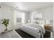 This bedroom boasts neutral paint, a large bed, and a window for natural light at 9359 Russell Cir, Arvada, CO 80007