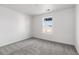 Carpeted bedroom with a window, freshly painted in neutral color at 9359 Russell Cir, Arvada, CO 80007