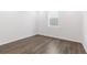 This empty room is awash in light from the single window, illuminating the plank flooring at 9359 Russell Cir, Arvada, CO 80007