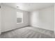 Bright bedroom with neutral walls and carpet and a view to the outside at 9359 Russell Cir, Arvada, CO 80007