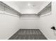 Walk-in closet features ample shelf space and plush gray carpeting at 9359 Russell Cir, Arvada, CO 80007