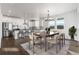Eat-in kitchen features an island with bar seating, stainless appliances, and an adjacent dining area for entertaining at 9359 Russell Cir, Arvada, CO 80007