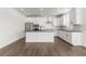 Bright kitchen features stainless steel appliances, an island with bar seating, and dark countertops at 9359 Russell Cir, Arvada, CO 80007