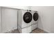 New, modern, front-loading, stacked washer and dryer set in laundry room at 9359 Russell Cir, Arvada, CO 80007