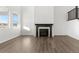 Cozy living room with a modern fireplace and view of stairway at 9359 Russell Cir, Arvada, CO 80007