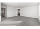 Spacious carpeted room with ample natural light and views of connected rooms in the house at 9359 Russell Cir, Arvada, CO 80007