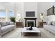 Inviting living room boasts a cozy fireplace, flanked by decorative lamps, and stylish sofas perfect for relaxation at 9359 Russell Cir, Arvada, CO 80007