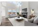 Bright living room features a fireplace, large windows, and high ceilings, creating an inviting and spacious atmosphere at 9359 Russell Cir, Arvada, CO 80007