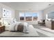 Bright primary bedroom features scenic views, neutral décor, and a spacious layout for ultimate comfort and style at 9359 Russell Cir, Arvada, CO 80007