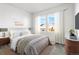 Serene primary bedroom with soft lighting, neutral tones, and ample natural light for a restful retreat at 9359 Russell Cir, Arvada, CO 80007