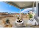 Outdoor patio with cozy seating around a fire pit for relaxation and entertainment at 9359 Russell Cir, Arvada, CO 80007