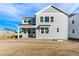 View of the home's rear featuring a covered porch and large windows for ample natural light at 9359 Russell Cir, Arvada, CO 80007