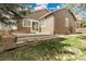 A well manicured backyard with a concrete patio and lots of trees at 5463 Rockhampton Cir, Highlands Ranch, CO 80130