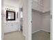 Bathroom with white vanity, framed mirror and door to the closet at 5463 Rockhampton Cir, Highlands Ranch, CO 80130