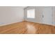 Light filled room with hardwood floors, large window, and white door at 5463 Rockhampton Cir, Highlands Ranch, CO 80130