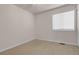 Small bedroom with a large window and neutral carpeting at 5463 Rockhampton Cir, Highlands Ranch, CO 80130