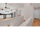 Open living area with hardwood floors connecting the kitchen and stairs in a cozy home at 5463 Rockhampton Cir, Highlands Ranch, CO 80130