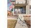 Inviting front porch with black railings and steps leading to the entrance at 11109 E 25Th Dr, Aurora, CO 80010