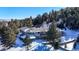 Aerial view of house and snowy landscape at 2824 Valley Park Dr, Larkspur, CO 80118