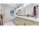 Modern bathroom with double vanity and walk-in shower at 2824 Valley Park Dr, Larkspur, CO 80118