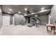 Large basement gym with cardio equipment and ample space at 2824 Valley Park Dr, Larkspur, CO 80118