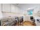 Bright laundry room with LG washer and dryer, and workspace at 2824 Valley Park Dr, Larkspur, CO 80118