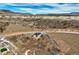 Aerial view of a modern luxury home and its surrounding arid landscape at 4121 Mesa Top Dr, Monument, CO 80132