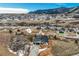 Aerial view of a modern luxury home showing the surrounding landscape and beautiful mountain views at 4121 Mesa Top Dr, Monument, CO 80132