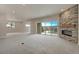 Spacious basement with stone fireplace, sliding glass doors, and neutral carpeting at 4121 Mesa Top Dr, Monument, CO 80132