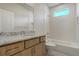 Bright bathroom with wooden vanity, granite counters, soaking tub and natural light at 4121 Mesa Top Dr, Monument, CO 80132