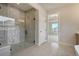 Bathroom with a glass-enclosed shower and modern fixtures, adjacent to bedroom with mountain views at 4121 Mesa Top Dr, Monument, CO 80132