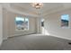 Spacious bedroom with large windows, mountain views, recessed lighting, and plush carpeting at 4121 Mesa Top Dr, Monument, CO 80132