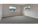 Cozy bedroom with neutral paint and carpet with two windows and lovely mountain views at 4121 Mesa Top Dr, Monument, CO 80132