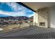 Covered deck with stone fireplace offers stunning views of the landscape at 4121 Mesa Top Dr, Monument, CO 80132