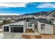 Beautiful modern home showcasing a three car garage and mountain views at 4121 Mesa Top Dr, Monument, CO 80132