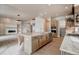 Modern kitchen boasts a central island, stainless steel appliances, and bright, open-concept design with hardwood floors at 4121 Mesa Top Dr, Monument, CO 80132