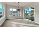 Bright living room with large windows, mountain views, and glass sliding door leading to an outdoor patio at 4121 Mesa Top Dr, Monument, CO 80132