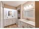 Bright bathroom with dual vanities, white cabinetry and new countertops at 13961 E Marina Dr # 414, Aurora, CO 80014