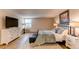 Bright bedroom featuring a plush rug, TV, and natural light from the window at 13961 E Marina Dr # 414, Aurora, CO 80014