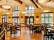 A view of the dining room with large windows and multiple tables and chairs at 13961 E Marina Dr # 414, Aurora, CO 80014