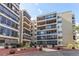 Exterior view of building with balconies, landscaping, and parking area with blue skies overhead at 13961 E Marina Dr # 414, Aurora, CO 80014
