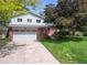 Two-story home with a brick facade and a spacious lawn at 954 Coral Ct, Castle Rock, CO 80104