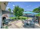 This backyard features a deck with seating and table, under a bright blue sky at 3313 S Dexter St, Denver, CO 80222